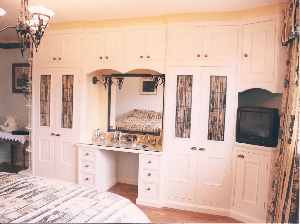Elegant wooden kitchen cabinetry with detailed craftsmanship, featuring a mix of open and closed storage spaces.